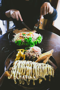 Midsection of person preparing food in kitchen