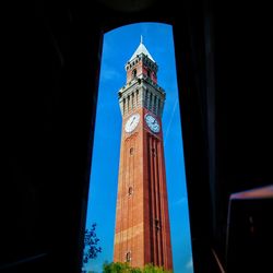 Low angle view of clock tower against sky