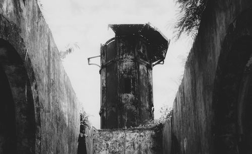 Low angle view of abandoned building against sky