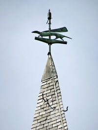 Low angle view of weather vane against clear sky