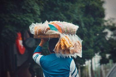 Rear view of woman holding umbrella