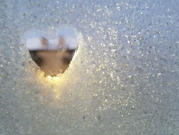 Close-up of heart shape in snow