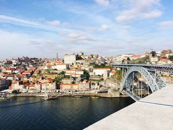 View of bridge over river against cloudy sky