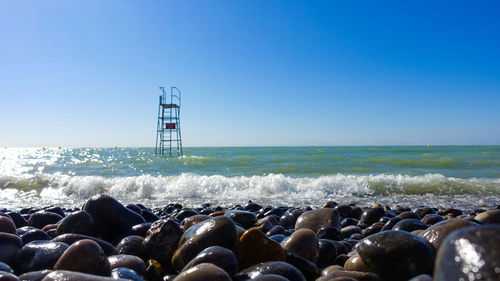 Scenic view of sea against clear blue sky