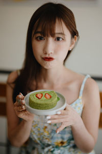 Portrait of smiling girl eating food at home