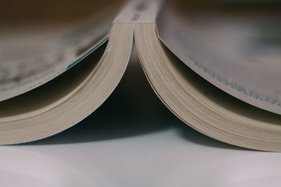 Close-up of upside down open book on table