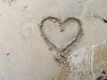 Close-up of heart shape on sand