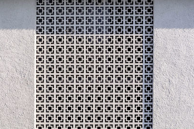 Full frame shot of patterned window amidst wall