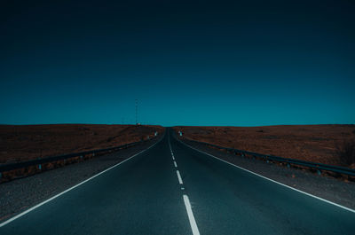 Empty road against sky at night