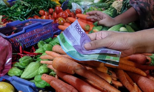 Midsection of vegetables at market stall