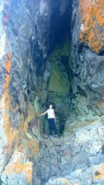 Full length of woman standing on rock formation