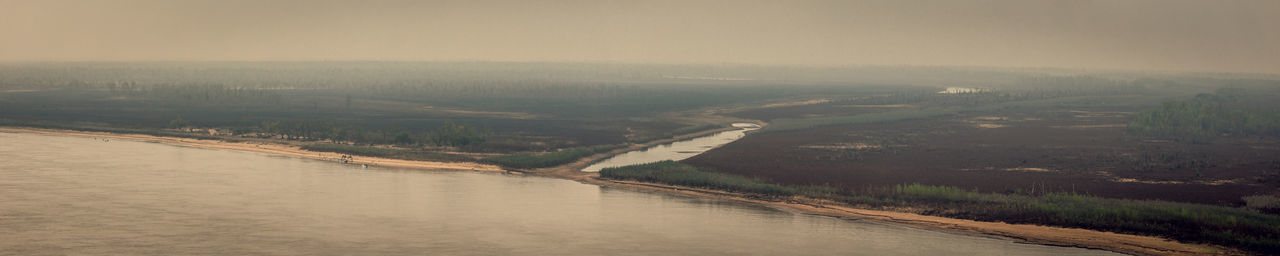 Aerial view of river amidst landscape against sky