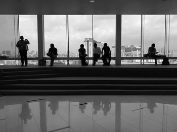 People sitting on benches in modern building