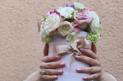 Midsection of woman holding bouquet of red rose