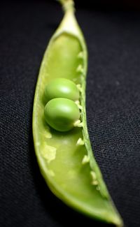 Close-up of green chili pepper against black background