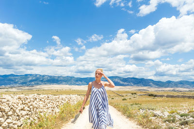 Full length of young woman standing on land