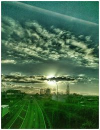 Scenic view of field against cloudy sky
