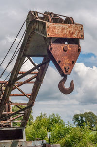 Low angle view of rusty metal against sky