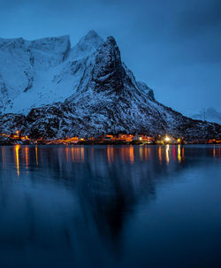 Illuminated houses and snowcapped mountains