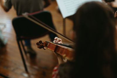 Rear view girl playing violin