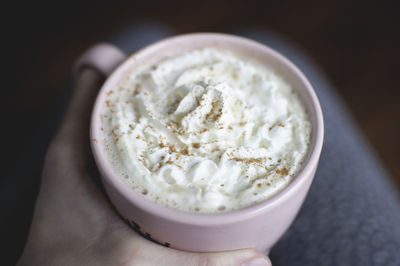 Close-up of hand holding coffee cup