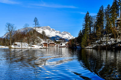 Scenic view of snowcapped mountains and trees against sky