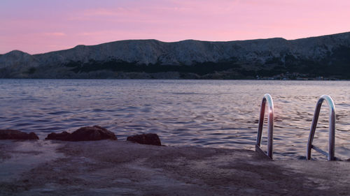 Scenic view of beach against sky during sunset