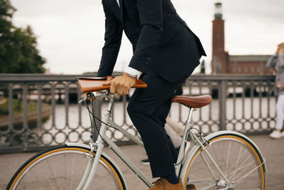 Man riding bicycle on railing