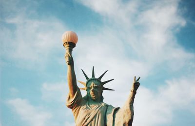 Low angle view of statue against cloudy sky