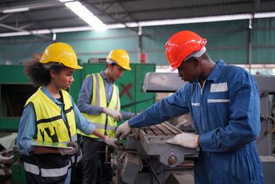 Rear view of men working at construction site