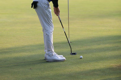 Low section of man playing golf