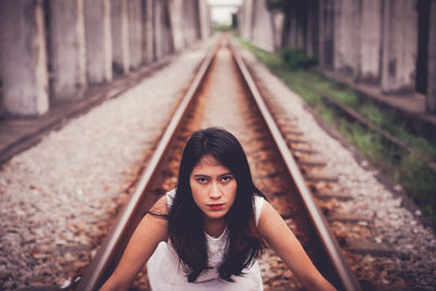 Portrait of a girl on railroad track