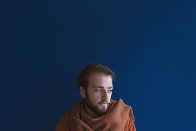 Portrait of man against blue sky