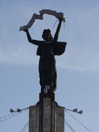 Low angle view of statue against sky