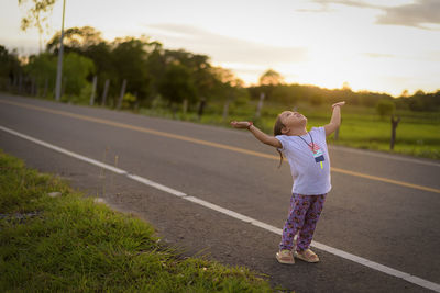 Full length of woman walking on road