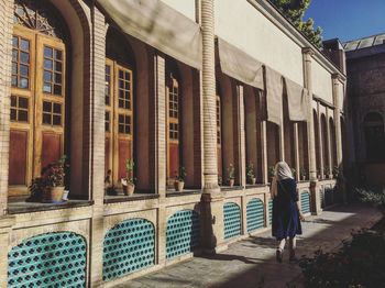 Woman standing in front of building