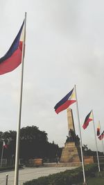 Low angle view of flag flags against sky