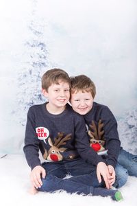 Happy friends sitting on shore