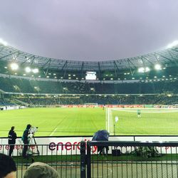 People on soccer field against sky