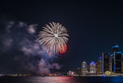 Low angle view of firework display at night