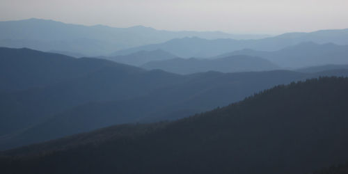 Scenic view of mountains against sky during foggy weather