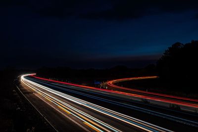 High angle view of light trails on highway at night