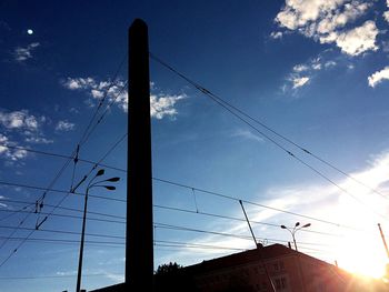 Low angle view of power lines against sky