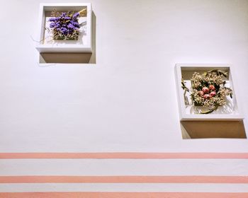 Dried plant arrangement against wall