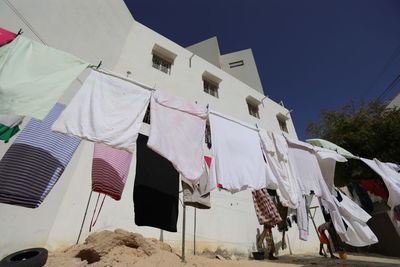 Low angle view of clothes drying against buildings