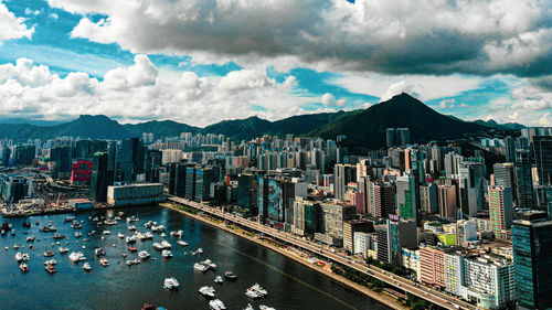 Panoramic view of city buildings against cloudy sky