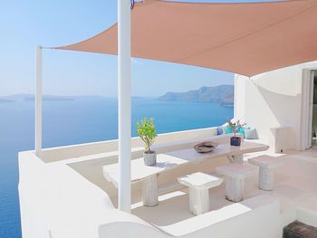 Scenic view of terrace furniture and sea against sky
