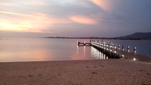 Pier on sea at sunset