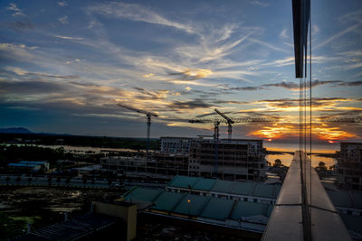 High angle view of illuminated buildings against sky during sunset