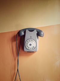 View of landline telephone next to wall